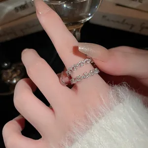 French style silver crisscross ring with zircons and wavy layers for a chic look
