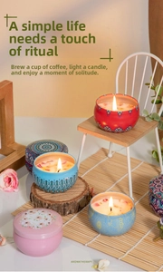 Macro shot of boho aromatherapy candles in tin cans with dried flower petal toppers