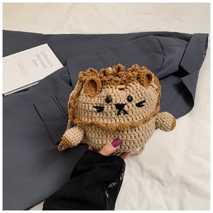 Detailed close-up of a handmade crochet lion drawstring bag with visible wool textures
