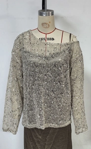 Detail eines silbernen Pailletten-Netzoberteils mit hohler Strickstruktur und Glanz
