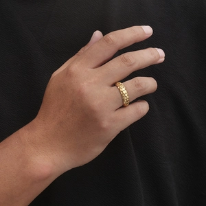 Golden punk snake scale textured stainless steel ring worn on hand with side view
