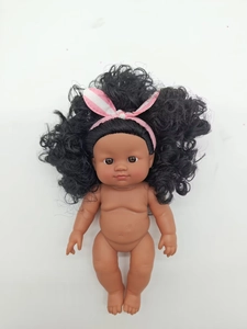 Detailed close-up of a realistic dark skin vinyl baby doll with black curly hair and headband