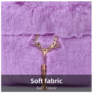 Detail showing plush purple faux rabbit fur texture with gold elk pendant ornament