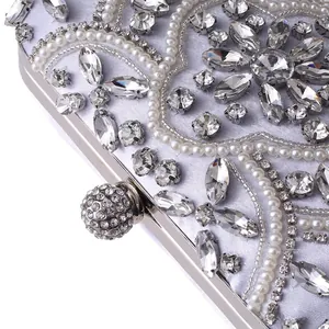 Detail of beaded evening bag with pearls, rhinestones, and silver floral patterns