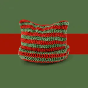 Detail of red and green striped knit beanie featuring cute handmade devil cat ears