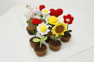 Macro view of assorted handmade crochet mini potted flowers with detailed yarn texture