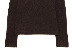 Detail of dark brown knit sweater showing fine ribbed cuffs and premium soft texture