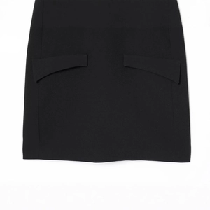 Minimalist black short dress featuring symmetrical curved pocket flaps and professional fabric