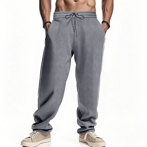 Close-up of grey corduroy sweatpants showing white side stripes and texture detail