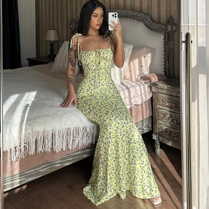 Detail of yellow floral sundress with ruched bust design and high waist on model