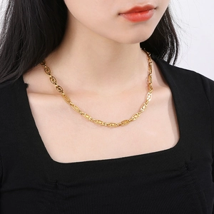 Detail of gold-plated stainless steel necklace with hollow oval geometric chain links