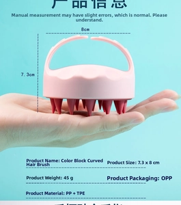 Silicone scalp massager detail showing pink handle and soft brown TPE bristles