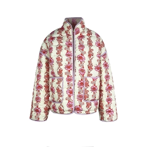 Close-up of quilted floral jacket with red flowers, purple piping and large pockets