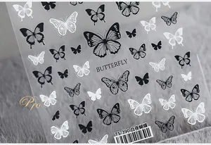 Close-up of TS-390 butterfly nail art stickers with black and white patterns