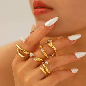 Gold plated stainless steel rings set with star heart zircon charms worn by a model