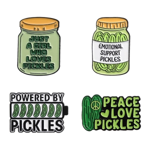 Set of 4 green enamel pins featuring 'Powered by Pickles' and 'Emotional Support' slogans