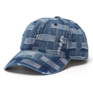 Detailed close-up of woven denim baseball cap with vintage distressed texture and frayed edges