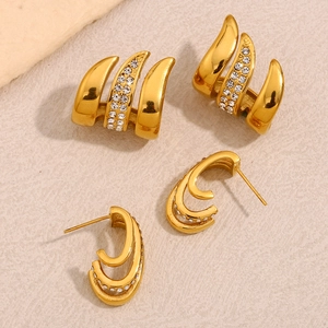 Detail of 18K gold plated multi-layer curved stud earrings with crystal zirconia