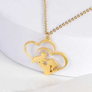 Detail of gold-plated stainless steel double heart pendant with mother and child silhouette