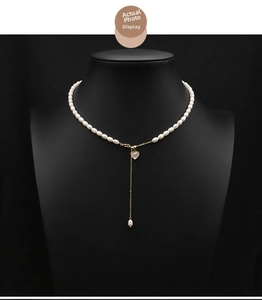 Detailed Y-shaped necklace view with natural white pearls and pink heart pendant