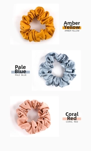 Three premium 19mm silk scrunchies in amber yellow, pale blue and coral red