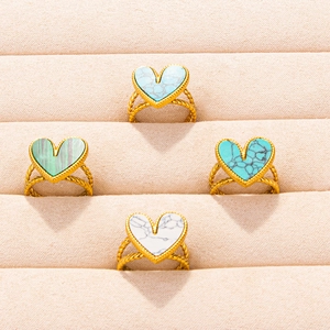 Set of four gold stainless steel heart rings with marble and turquoise stone textures