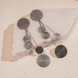 Detail of gunmetal grey fringe earrings with spiral textured round metal discs