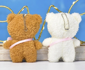 Back view of 12cm plush bear keychain pendants with pink ribbons and ball chains.