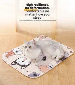 Detailed quilted pet mat with cartoon prints and a cozy cat resting on soft fabric