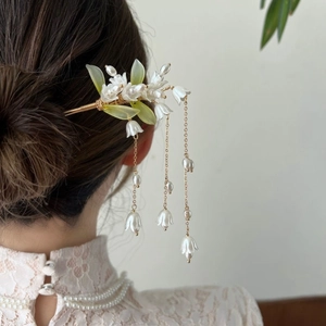 Elegant lily of the valley hair stick with white tassels and pearls on model back