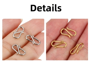Detail showing small gold and silver S-shaped stainless steel jewelry clasps on fingers