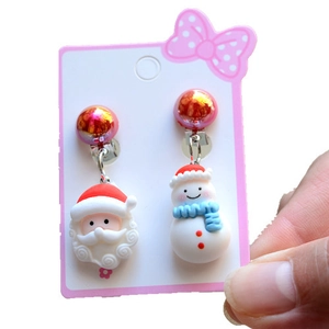Detail view of cute Christmas Santa and snowman clip-on earrings for kids without piercings