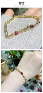 Detail of 18K gold plated bracelet with oval red rubies and sparkling zircon stones