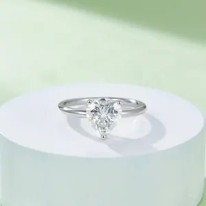 Elegant sterling silver ring with a 2-carat heart-shaped moissanite stone on a white stand