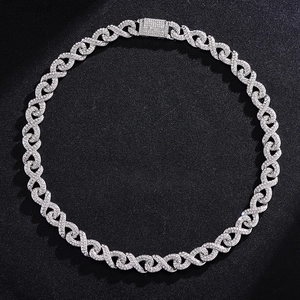 Macro shot of silver hip-hop chain with sparkling infinity links on black texture