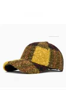 Close-up of yellow and brown checkered sherpa baseball cap showing fuzzy wool texture