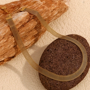 Detail view of 18K gold plated stainless steel mesh choker necklace on stone
