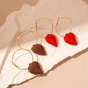 Vintage gold hoop earrings with red and brown acrylic heart charms on stone base