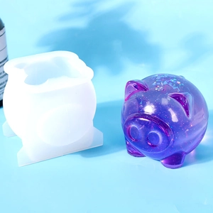 Macro shot of pig-shaped silicone mold with glittery purple resin DIY craft on blue surface