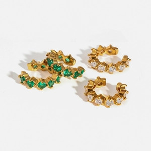 Detailed view of C-shaped 18K gold stainless steel ear cuffs with green and white zircons