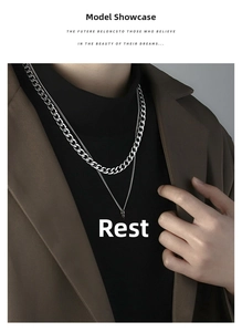 Close-up of double-layered silver cuban chain necklace with 1996 number pendant on a model