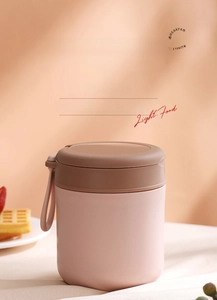 Close-up of portable pink insulated soup cup with convenient soft handle for breakfast