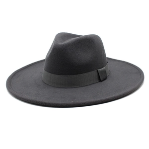 Macro detail of dark grey wide brim wool fedora hat showing texture and grosgrain ribbon