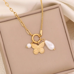 Gold butterfly and pearl pendant necklace with double-style chain in a beige jewelry box