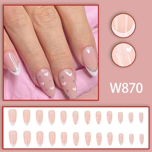 French almond press-on nails with pink base, white hearts, and silver glitter accents