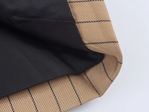 Detailed macro view of striped linen blend fabric with premium black inner lining finish