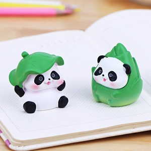 Cute mini panda figurines with lotus leaf and bamboo shoot on a desk decoration