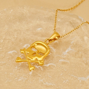 Close-up of hip hop style 18k gold plated skull and crossbones pendant necklace