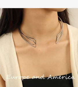 Detail of silver metallic open collar necklace with sleek minimalist multi-line design