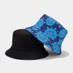 Detail of vintage bucket hats in black and blue with evil eye mandala embroidery
